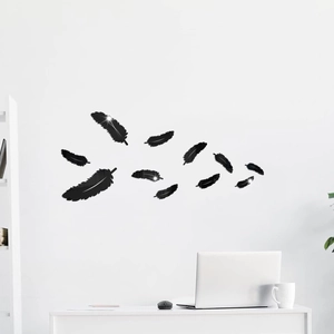 Detail of 11-piece black mirror acrylic feather wall stickers in a modern office setup