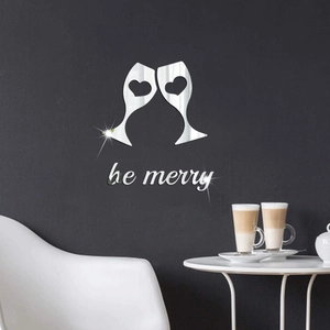Close-up of silver mirror wall stickers featuring wine glasses and be merry letters