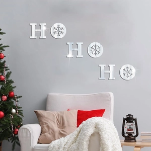 Close-up of silver mirror HO HO HO Christmas snowflake wall stickers on grey background