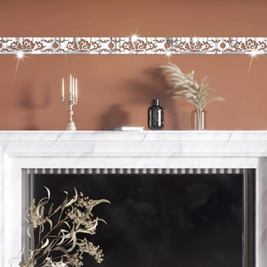 Detail of silver mirror acrylic wall border with Chinese Ruyi cloud pattern on fireplace