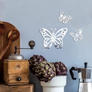 Detail of 3D mirror butterfly wall stickers with intricate hollow patterns on blue wall