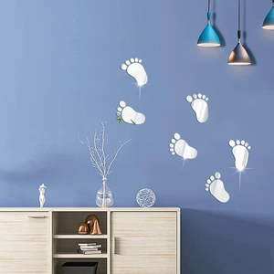 Detail of mirror acrylic footprint wall stickers on a dark blue background with home decor