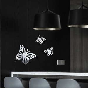 Macro shot of 3D silver mirror butterfly wall stickers with intricate hollow patterns