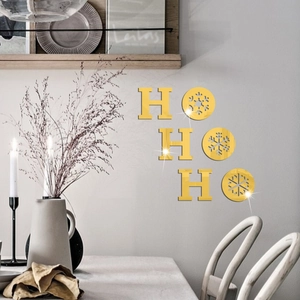 Close-up of golden mirror HO HO HO Christmas wall stickers with snowflake design for home decor