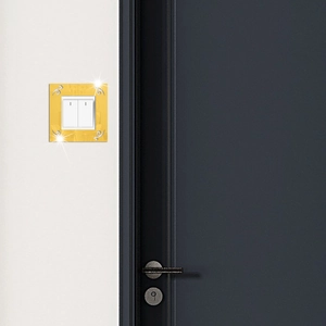 Detail of gold mirror acrylic wall sticker for light switch with silver scroll patterns