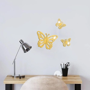Three gold 3D hollow butterfly mirror wall stickers in varying sizes for bedroom decor