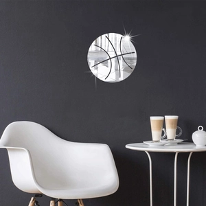 Modern acrylic basketball mirror wall sticker on a dark wall above a minimalist table