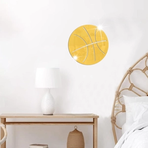 Macro detail of golden acrylic basketball wall mirror decor in a minimalist bedroom setting