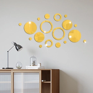Detail of various sized gold mirror circle acrylic wall decals in a modern living room