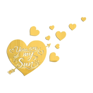 Detail of golden acrylic mirror wall stickers with You are my Sun text and heart shapes