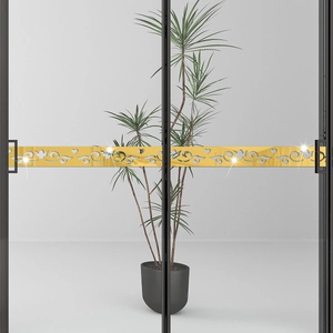 Detailed view of gold mirror acrylic waistline sticker with ornate cutouts on glass doors