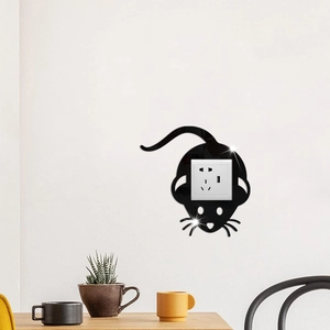 Detail of glossy black acrylic mouse wall sticker around a modern socket in a cozy room