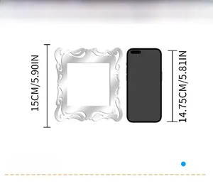 Size comparison of silver acrylic mirror wall decal sticker next to a smartphone