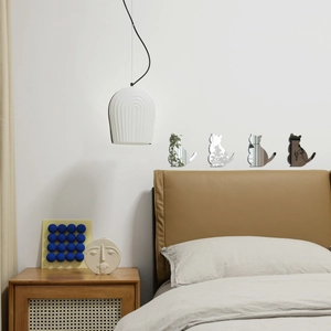 Detailed mirror-finish acrylic cat wall stickers in a modern minimalist bedroom set