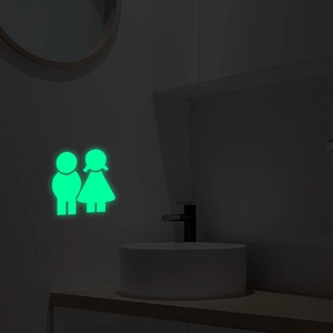 Luminous gender icons wall sticker glowing green in dark bathroom setting