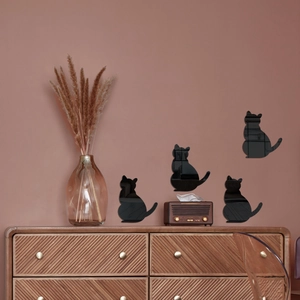 Detail of black acrylic cat mirror wall stickers in a cozy home decor setting