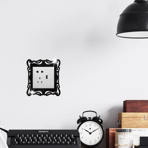 Close-up of black retro acrylic light switch cover with vintage lace frame decoration