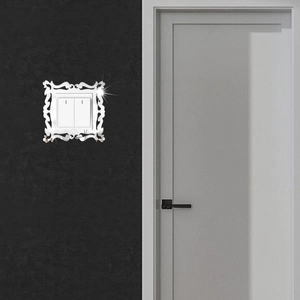 Macro shot of silver acrylic mirror wall decal for double light switch with vintage patterns