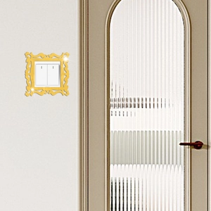Detail view of gold acrylic mirror light switch cover with vintage European floral pattern
