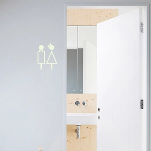 Stickers muraux lumineux pour toilettes montrant des icônes homme et femme en vert