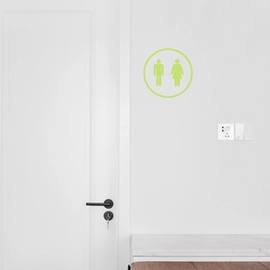 Luminous green restroom sign wall sticker with male and female icons on white door