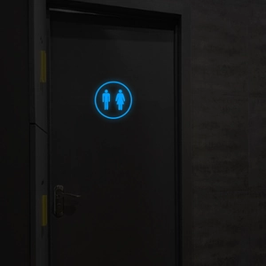 Glow-in-the-dark bathroom door sticker featuring blue luminous male and female icons