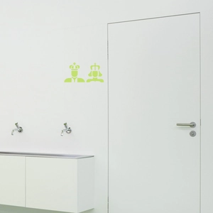 Luminous green restroom stickers with crown silhouettes on a minimalist white door
