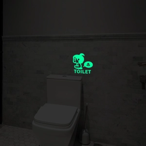 Leuchtender grüner WC-Wandaufkleber mit Cartoon-Figur und TOILET-Text für das Bad