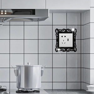 Detailed macro view of black acrylic decorative socket frame with elegant hollowed-out patterns