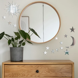 Modern mirror wall stickers featuring sun, moon and stars in a cozy home interior setting