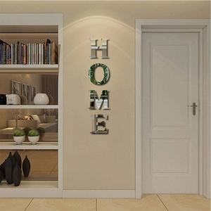 Close-up of 3D silver acrylic mirror wall stickers showing HOME letters in a vertical layout
