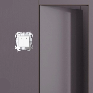 Macro shot of silver mirrored acrylic switch plate with baroque floral carving detail