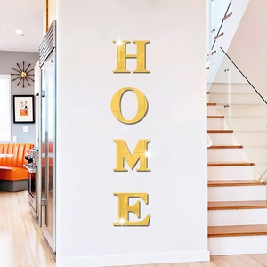 Close-up of 3D gold mirror acrylic HOME wall stickers with reflective metallic finish