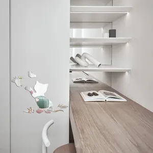 Detail shot of reflective cat and butterfly acrylic mirror wall stickers on a white cabinet
