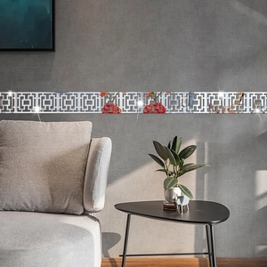 Close-up of silver mirror Greek key wall stickers on a modern grey living room wall
