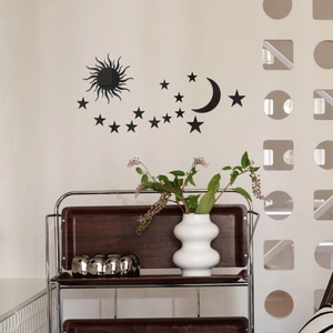 Detail of black acrylic wall stickers with moon and stars set in a modern room decor