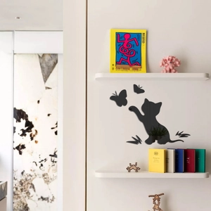 Detail of black acrylic cat and butterfly mirror wall stickers on a white bedroom wall