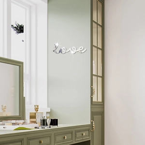 Silver 3D acrylic mirror wall sticker with Love letter design on a light green wall
