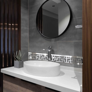 Silver mirror acrylic wall sticker with hollow geometric pattern in a modern bathroom setup