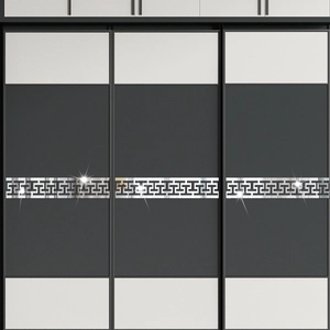 Macro detail of silver acrylic mirror wall decals with Chinese fret pattern on wardrobe