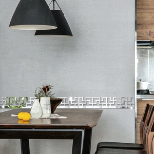 Close-up of silver mirror acrylic wall stickers with geometric hollow fretwork design