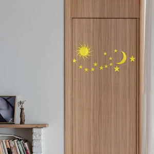 Detail view of yellow mirror acrylic moon and stars wall stickers on a wooden door