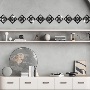 Macro detail of black geometric mirror wall stickers with intricate Celtic knot patterns