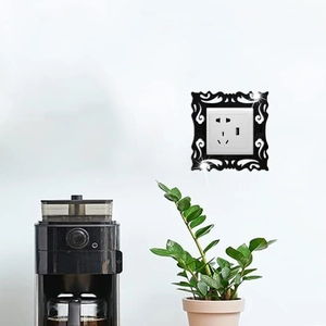Detail of black acrylic mirror light switch wall sticker with elegant floral pattern
