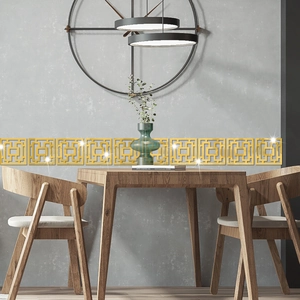 Detail of golden mirror geometric wall stickers with Chinese fret patterns in a modern dining room