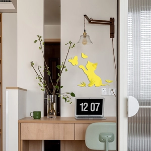 Detailed view of yellow acrylic cat and butterfly mirror wall decals in a modern room