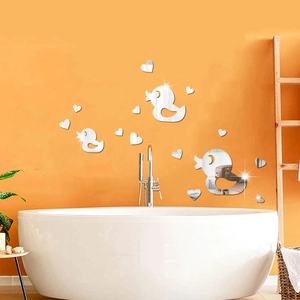 Close-up of duck and heart mirror wall stickers in a warm orange bathroom setting