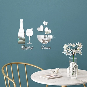Detail of silver acrylic mirror wall stickers with wine glass and heart shapes on blue wall