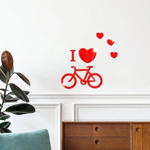 Macro detail of red acrylic mirror 3D wall decal featuring bicycle and heart patterns