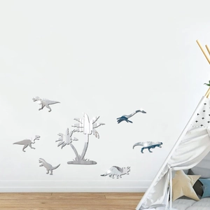 Macro shot of silver dinosaur and palm tree mirror wall stickers on a clean white wall